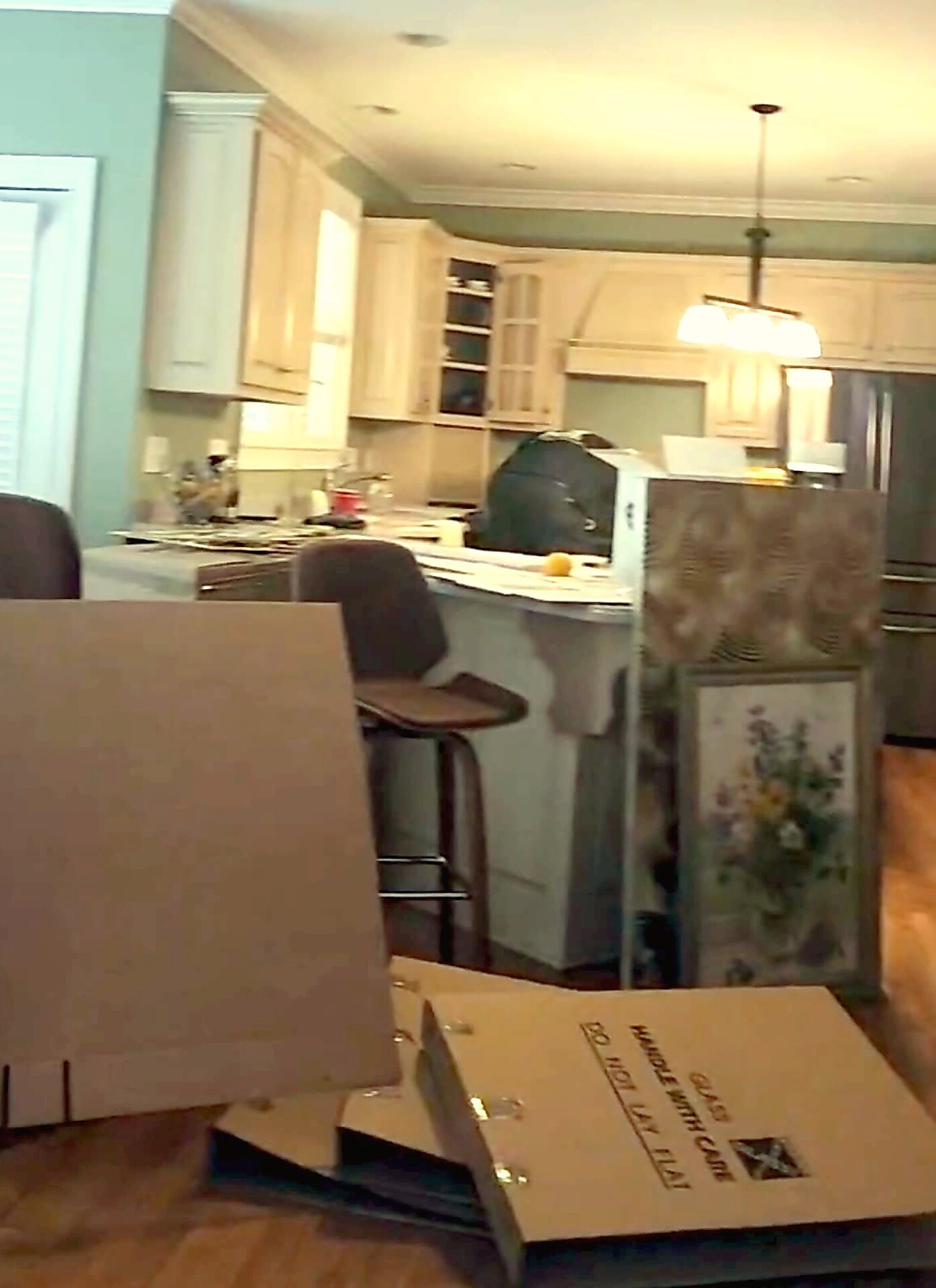 Moving boxes being assembled in a kitchen