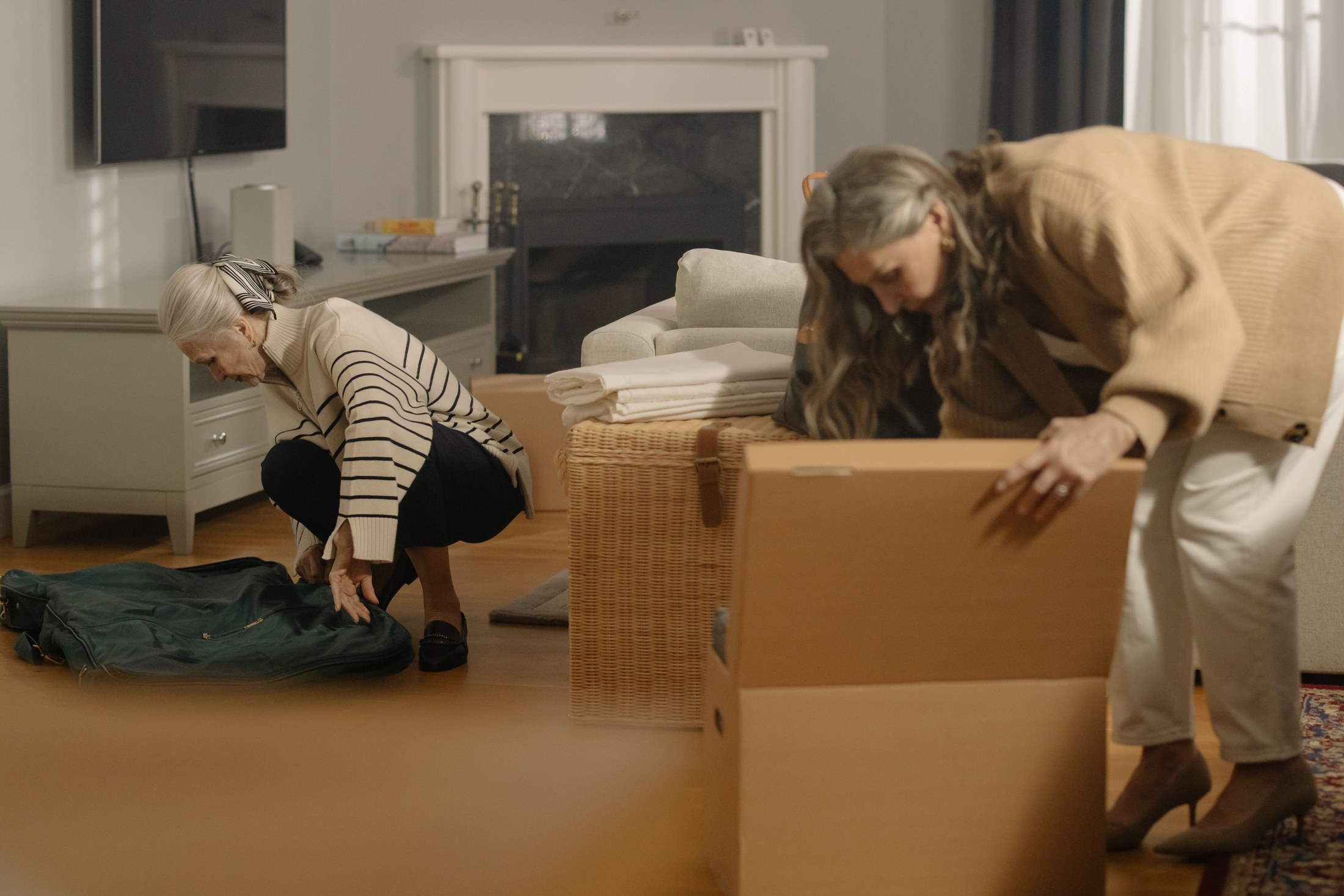 Two women preparing belongings for a home move